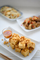 Deep fried tofu is cut into square balls on plate