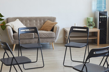 Background image of empty chairs in circle ready for therapy session or support group meeting, copy space