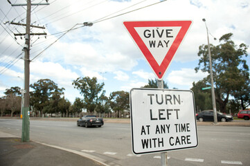 Road sign Turn left at any time with care. Australia, Melbourne. Warning sign.  Give way.