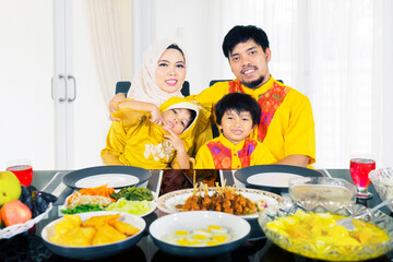 Happy Muslim family sitting in the dining table