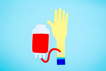 Top view of paper hand doing blood transfusion