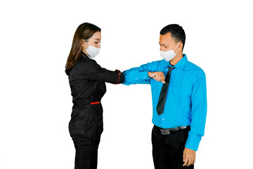 Two business people greeting with elbows on studio