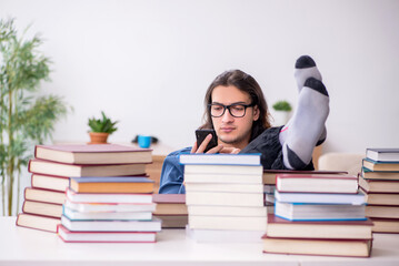 Young male student preparing for exams at home