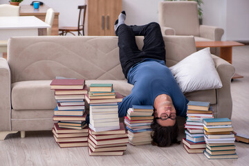 Young male student preparing for exams at home