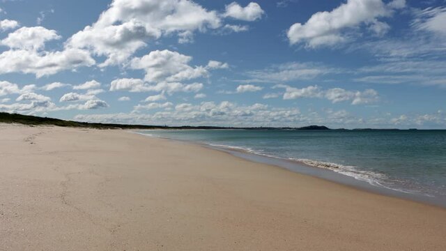 Huskisson Beach on the middle of Jervis Bay Australia empty on a sunny cloudy day, Locked shot