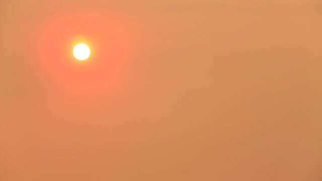 Dimmed Sun Mostly Obscured By Wildfire Smoke In An Orange Sky