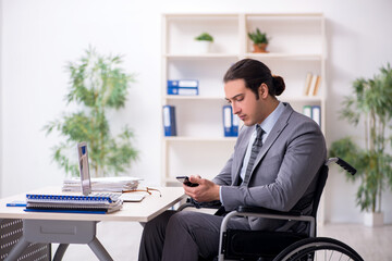 Young male employee in wheel-chair