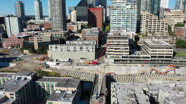 Drone footage of the current construction near the Pike Place Market in Seattle downtown, waterfront, piers, empty Alaskan Way with skyscrapers, during the pandemic