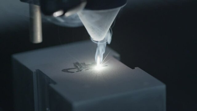 Extreme Closeup of Laser Engraving Machine Etching Design into Metal Block