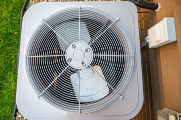 Top view of  Residential air conditioning unit outdoors with fan and coils