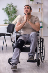 Fototapeta premium Young leg injured man in wheel-chair