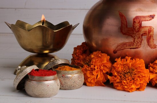 copper kalash with coconut and mango leaf with haldi kumkum floral decoration. essential in hindu puja.