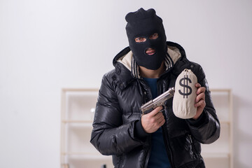 Young male burglar in the office