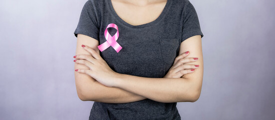 Women with pink ribbons attached to their breasts indicate or know about breast cancer. Concept of health care and medicine.