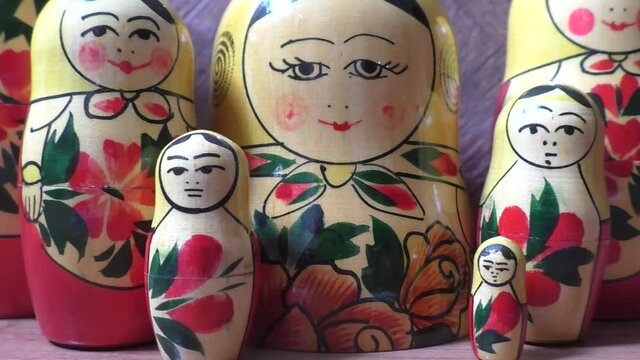 Matryoshka - Russian folding doll made of wood, inside which there are dolls of smaller size. Semenovskaya matryoshka is painted bright, with black hair, a handkerchief on her head. Retro