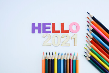 Colored hello 2021 text with colored pencils on white background 