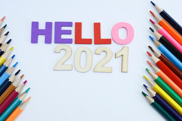 Colored text on hello 2021 with colored pencils on white background 