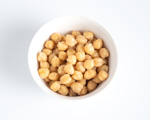 Top view of  cooked chickpeas in white bowl. Healthy food concept