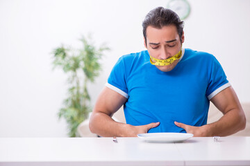 Young hungry man in dieting concept