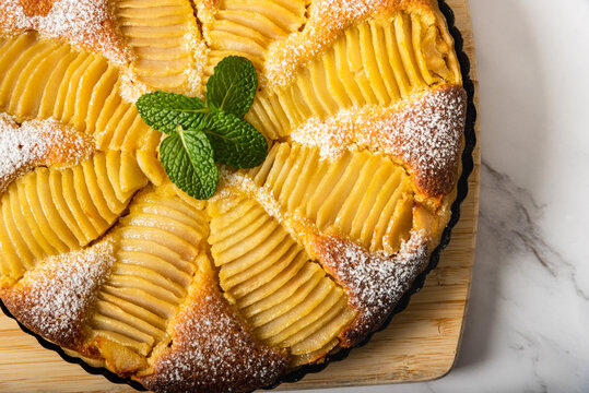 Homemade pear tart on a marble background