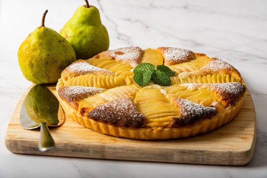 Homemade pear tart on a marble background