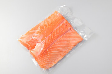 Salmon fillets in a vacuum package. Sous-vide, new technology cuisine. Selective focus, copy space