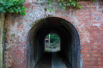 small tunnel made of bricks in town of takao, tokyo, japan