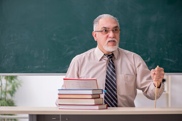 Old male teacher in the classroom