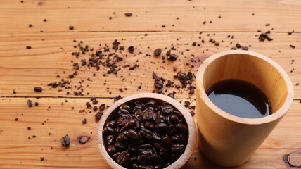 coffee beans and cup on the wooden background.