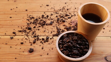 coffee beans and cup on the wooden background.