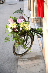 Fototapeta na wymiar Old bicycle with colorful flowers in a basket