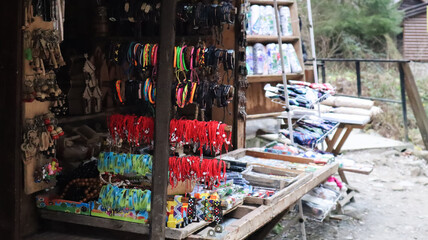 Souvenir market in Yaremche with traditional Carpathian handmade clothing, herbs and wooden tools. Ukrainian textiles, knitted socks, vests, hats. Ukraine, Yaremche - November 20, 2019