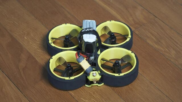 Close up shot of FPV drone BumbleBee CineWhoop with LiPo battery plugged in