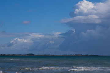 wind turbines with dramatic cumulus clouds