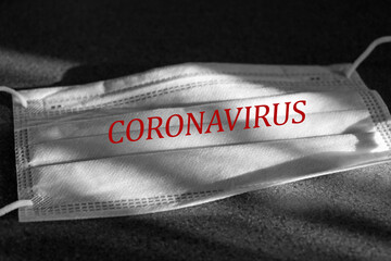 Medical mask with the inscription CORONAVIRUS to fight against COVID - 19.