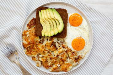 Tasty Homemade Fried Hashbrowns and Eggs on a plate, top view. Flat lay, overhead, from above.