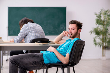 Two male pupils in bullying concept in the classroom