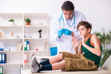 Sick boy visiting young male doctor pediatrician © Elnur