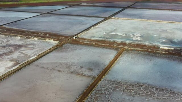 Aerial shot of the Pedra de Lume salt evaporation ponds, inside the crater of an extinct volcano. Camera flies over the salt ponds.