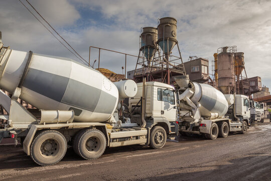 A row of concrete mixers awaiting loading at a concrete mixing station. For construction work.