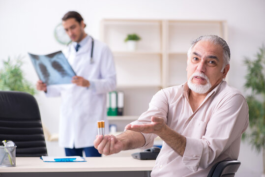 Young male doctor and old patient in antismoking concept