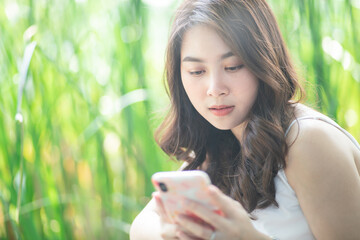 Beautiful asian women typing smartphone for social network