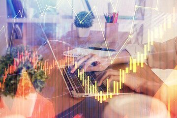 Double exposure of woman hands typing on computer and forex chart hologram drawing. Stock market invest concept.