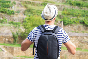 tourist with backpack walking through the countryside