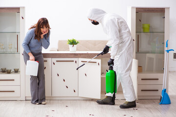 Young male contractor and female client during pest control