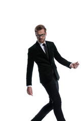 sexy cool young businessman looking down and walking