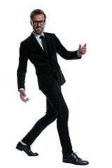 elegant cool man in black suit smiling and walking