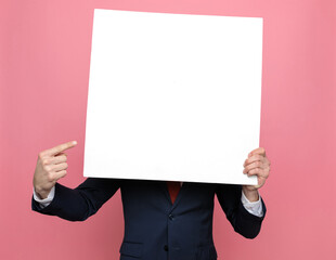 elegant fashion model hiding behind white empty board