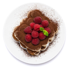 portion of Classic tiramisu dessert with raspberries on ceramic plate isolated on white background - clipping path