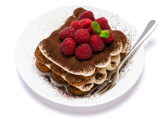 portion of Classic tiramisu dessert with raspberries on ceramic plate isolated on white background - clipping path